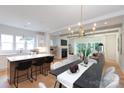 A view of the open concept kitchen, dining and living room with access to outside, and lots of natural light at 1728 Dallas Ave, Charlotte, NC 28205