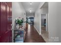 Inviting foyer with wood floors featuring coat closet and views into living spaces at 185 Willow Valley Dr, Mooresville, NC 28115