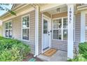 Cozy front porch with 'Welcome' mat and windows, offering a warm entrance at 1925 Sandal Brook Rd, Indian Land, SC 29707