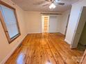 Bright bedroom with wooden floors, natural light, and a sliding barn door leading to the bathroom at 2131 E Nc 10 Hwy, Conover, NC 28613
