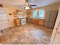 Bright kitchen featuring stainless steel refrigerator, natural wood cabinets and updated appliances at 2131 E Nc 10 Hwy, Conover, NC 28613