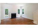 Bright living room with hardwood floors, a fireplace, and a door to the outdoor patio at 2180 Shady Pond Dr, Clover, SC 29710