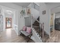 Bright foyer featuring a staircase, bench seating, and light wood flooring at 229 Cramerton Mills Pkwy, Cramerton, NC 28032