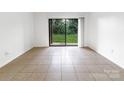 Bright living room with tile floors and sliding glass doors to the outside at 326 Orchard Trace Ln # 3, Charlotte, NC 28213