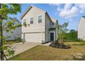 Inviting two-story home featuring a cozy front yard and an attached two-car garage at 4013 Southern Pine Dr, Mount Holly, NC 28120