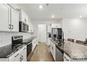 Modern kitchen featuring white cabinets, stainless steel appliances, and granite countertops at 4013 Southern Pine Dr, Mount Holly, NC 28120