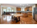 Spacious kitchen with wood cabinetry, a central island, and plenty of natural light at 4201 Amber Leigh Way Dr, Charlotte, NC 28269
