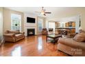 Inviting living room featuring a fireplace, hardwood floors, and seamless access to the kitchen at 4201 Amber Leigh Way Dr, Charlotte, NC 28269