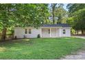 Attractive home featuring a brick facade, a covered porch, and a well-manicured lawn, providing a welcoming curb appeal at 4410 Burgin St, Kannapolis, NC 28081