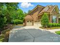 Spacious three-car garage featuring a long driveway and views of the well-maintained home at 463 Langston Place Dr, Fort Mill, SC 29708
