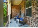 Inviting front porch with stone accents, rocking chairs, and a cozy outdoor rug at 463 Langston Place Dr, Fort Mill, SC 29708