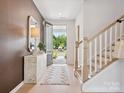 Inviting entryway featuring stylish decor, wood floors, and an open view of the outdoors at 502 Webster Ln, Cramerton, NC 28032