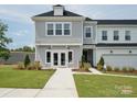 Charming two-story townhome featuring a gray exterior, manicured landscaping, and an attached garage at 502 Webster Ln, Cramerton, NC 28032