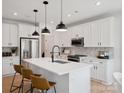 Modern kitchen with white cabinetry, stainless steel appliances, and a spacious center island at 502 Webster Ln, Cramerton, NC 28032