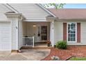 Close up of front entrance featuring a covered porch, painted door, and a manicured garden at 510 Sw Viking Sw Pl, Concord, NC 28025