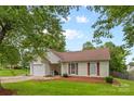 Inviting single-Gathering home featuring a manicured lawn and attached garage at 510 Sw Viking Sw Pl, Concord, NC 28025