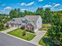 View of a two-story home with manicured lawn, trees, driveway, and neighboring houses at 511 Rough Hewn Ln, Rock Hill, SC 29730