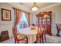 Formal dining room with wainscoting, elegant furniture, and a decorative hutch at 511 Rough Hewn Ln, Rock Hill, SC 29730