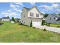 Charming house with a two-car garage, well-kept lawn, and neat landscaping, set in a Gathering-friendly neighborhood at 635 Scarlet Leaf Ln, Oakboro, NC 28129