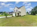 Beautiful home with a lush green lawn, mature trees, and a well-manicured landscape surrounding the property at 635 Scarlet Leaf Ln, Oakboro, NC 28129