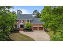 Stately brick home with a manicured lawn and two-car garage at 6916 Cameron Glen Dr, Charlotte, NC 28210