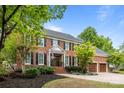 Elegant brick home with a manicured lawn and two-car garage at 6916 Cameron Glen Dr, Charlotte, NC 28210