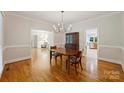 Traditional dining room boasting hardwood floors, chandelier and decorative molding; adjacent to living room at 7117 Cobblecreek Dr, Weddington, NC 28104