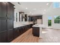 Kitchen with stainless appliances, an island, dark cabinets, and plenty of natural light at 716 Flare Dr, Tega Cay, SC 29708