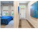 Hallway view with striking artwork leading to a bedroom and an exterior door at 819 Anderson St, Charlotte, NC 28205