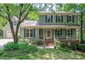Charming two-story home featuring an inviting front porch and a well-manicured lawn at 9928 Raddington Ln, Charlotte, NC 28269