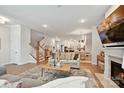 Inviting living room with hardwood floors, a fireplace, and open layout connecting to the kitchen and dining area at 10022 Wayfair Meadow Ct, Charlotte, NC 28277