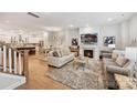 Bright, open-concept living space with hardwood floors, a fireplace, and seamless flow to the kitchen at 10022 Wayfair Meadow Ct, Charlotte, NC 28277