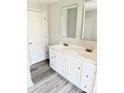 Bright bathroom with double vanity, modern fixtures, and laminate flooring at 1012 4Th St, Statesville, NC 28677