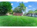 Spacious backyard with lush green grass and mature trees creating shade at 106 Valley Rd, York, SC 29745