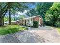 Lovely exterior view of home's front, landscaped yard, and long driveway at 106 Valley Rd, York, SC 29745
