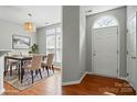Bright dining area featuring modern lighting, stylish furnishings, and beautiful wood flooring at 10867 Garden Oaks Ln, Charlotte, NC 28273