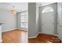 Bright entryway with hardwood floors, arched doorway, and natural light at 10867 Garden Oaks Ln, Charlotte, NC 28273