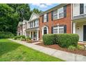 Attractive townhome with brick facade, manicured lawn, and black shutters at 10867 Garden Oaks Ln, Charlotte, NC 28273