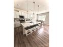 Bright kitchen with white cabinets, quartz countertops, and a large center island at 110 White Apple Way, Statesville, NC 28625
