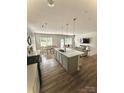 Open-concept kitchen with modern island, pendant lighting, and stainless steel appliances at 110 White Apple Way, Statesville, NC 28625