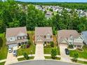 Aerial view of a suburban neighborhood showcasing well-maintained homes and tree-lined streets at 11070 River Oaks Nw Dr, Concord, NC 28027