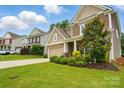 Lovely two-story house boasting lush greenery, a well-kept lawn, and a charming front facade at 11070 River Oaks Nw Dr, Concord, NC 28027