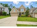 Inviting two-story home with a manicured lawn, beautiful landscaping, and a two-car garage at 11070 River Oaks Nw Dr, Concord, NC 28027