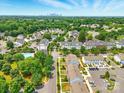 Aerial view showcases a residential community with lush greenery, a pool, and convenient parking at 1134 Plaza Walk Dr, Charlotte, NC 28215