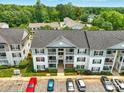 Three story condominium building with a rear parking lot at 1134 Plaza Walk Dr, Charlotte, NC 28215