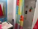 Bathroom with a shower, sink and colorful curtain at 120 Starboard Trl, Mount Gilead, NC 27306