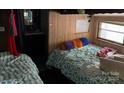 Bedroom featuring two twin beds with patterned bedding and natural lighting at 120 Starboard Trl, Mount Gilead, NC 27306