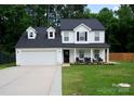 Attractive two-story home with an attached garage, covered front porch and a well-kept lawn at 12150 Plover Dr, Charlotte, NC 28269