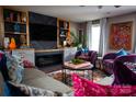 Cozy living room boasts custom shelving, fireplace, and designer touches at 12150 Plover Dr, Charlotte, NC 28269