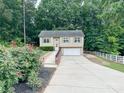 Charming two-story home with a spacious driveway and well-maintained landscaping at 125 Shenandoah Loop, Troutman, NC 28166
